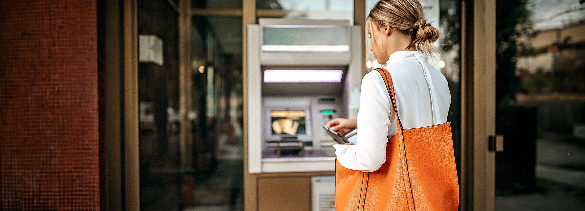 woman visiting ATM