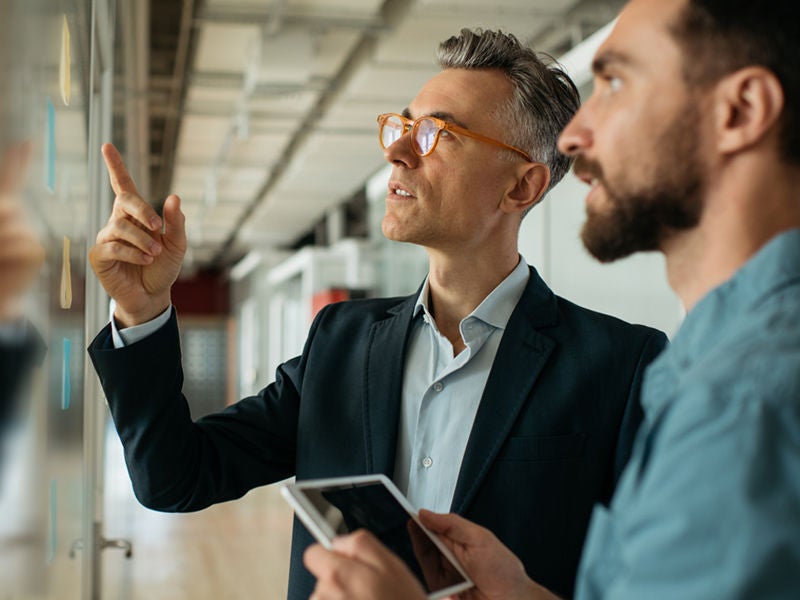 two men looking at data